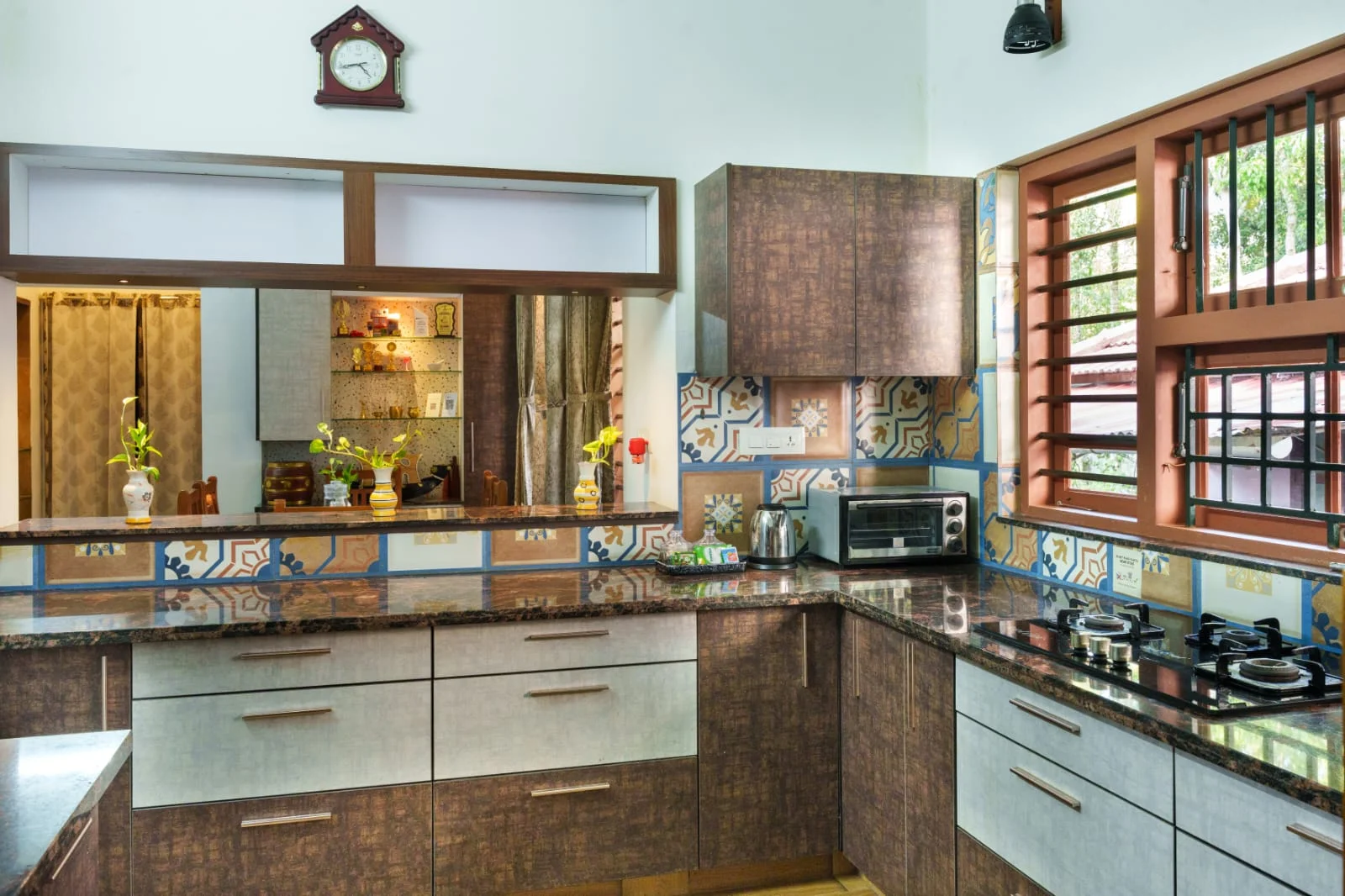 The homestay kitchen with wooden cabinets and patterned tiles