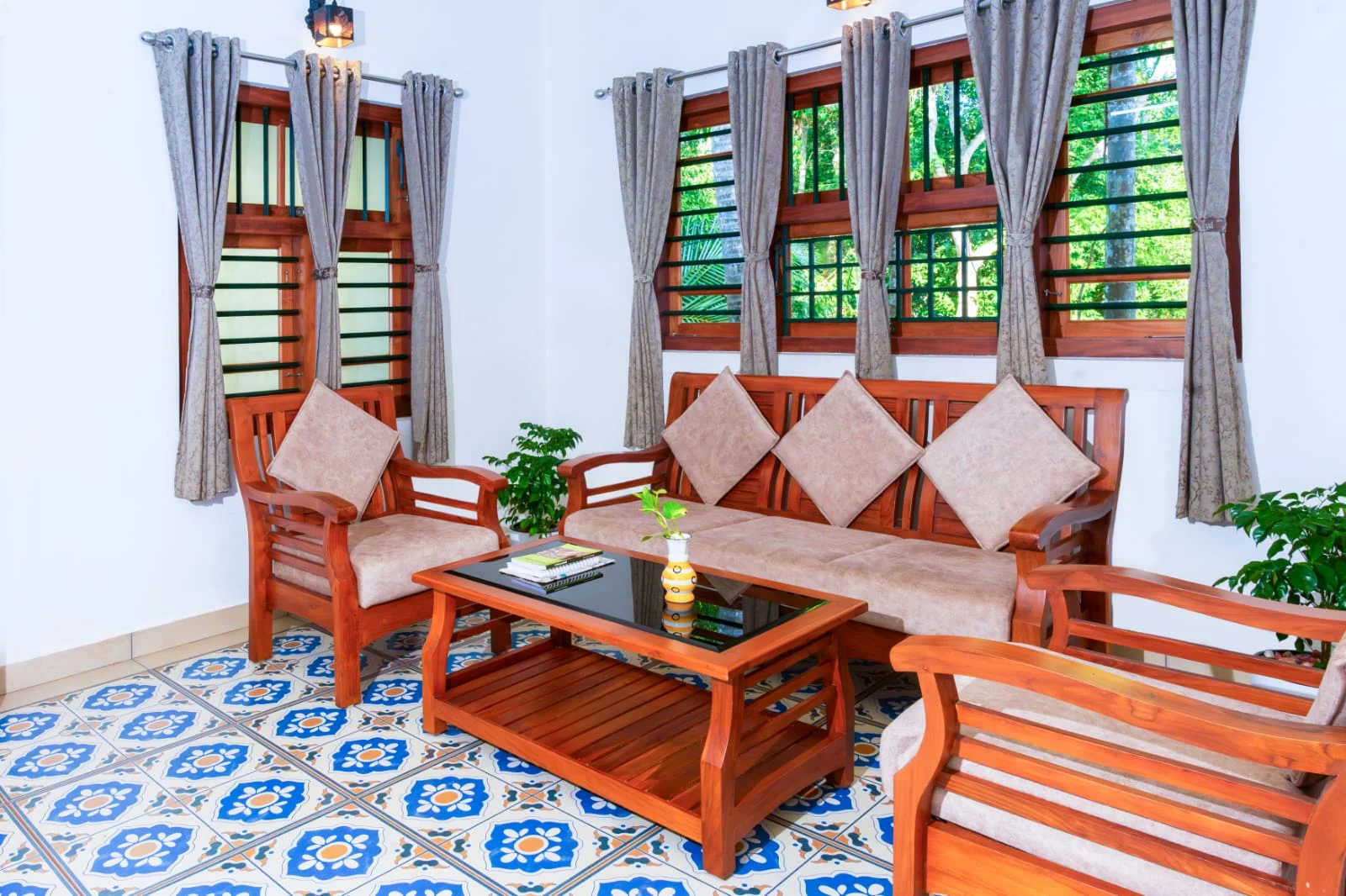 Niramaya’s shared living room with wooden seating and patterned floors