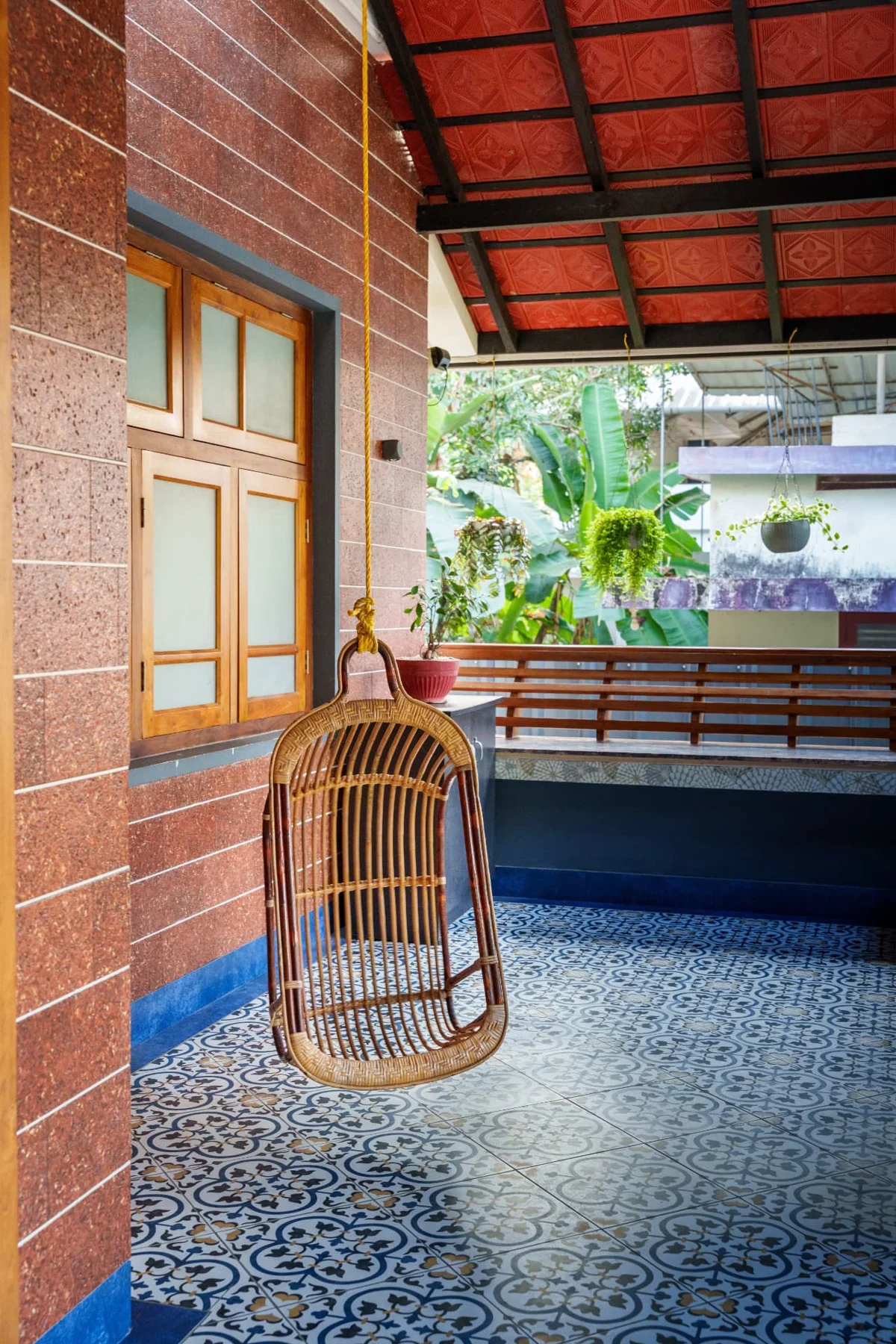 Niramaya veranda with a hanging wicker chair