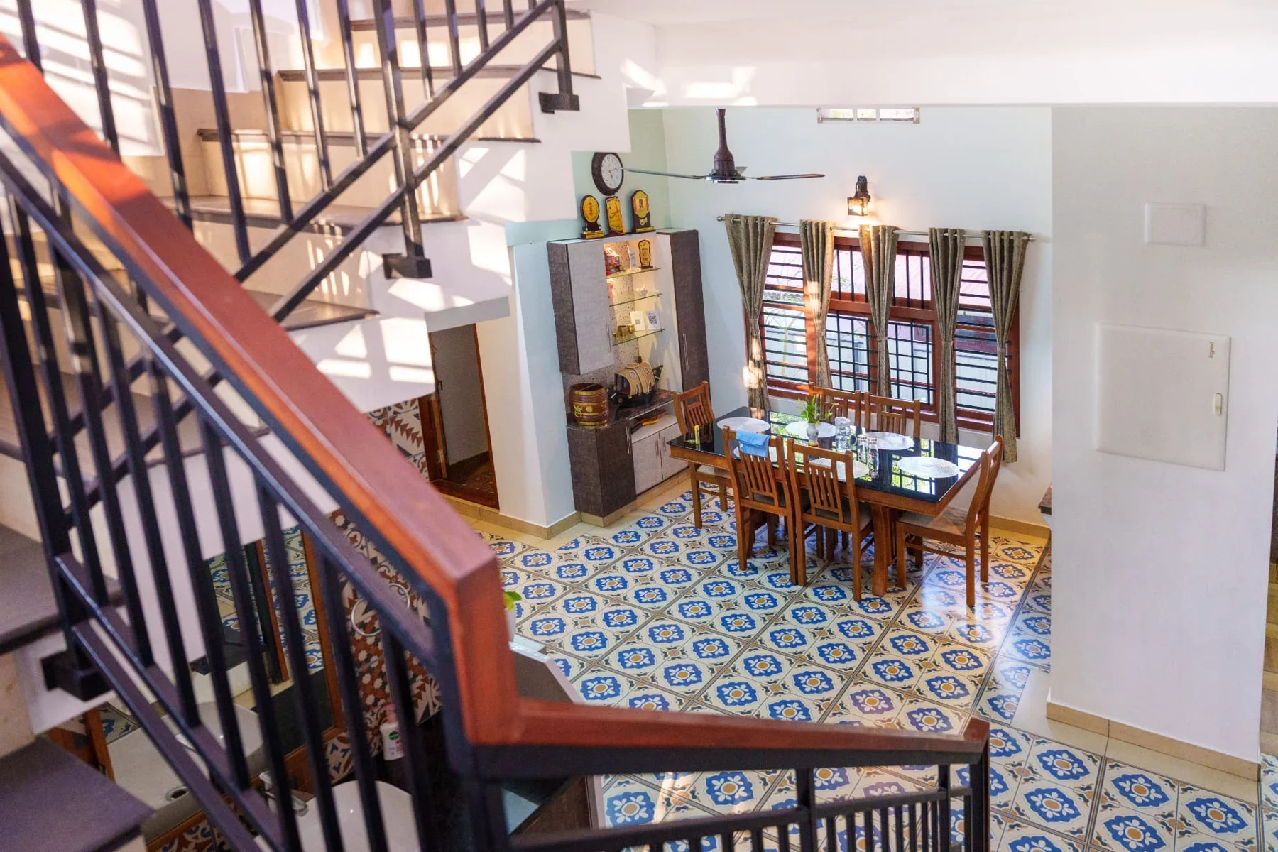 Wooden staircase and welcoming dining area at Niramaya